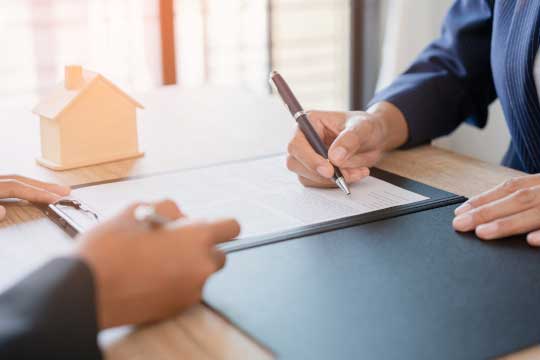 Financing Home in Greenwood Village, CO Self-employed person signing mortgage agreement